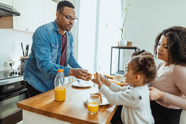 istock Family with two little daughters enjoying breakfast together 2229237385