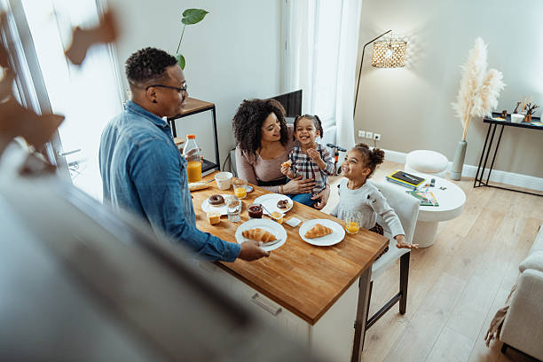 istock Family with two little daughters enjoying breakfast together 2229237401
