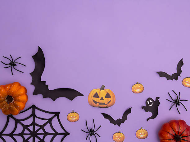 istock A flat composition with pumpkins, a spider web and a bat on a purple background, a place for text. 2229237604
