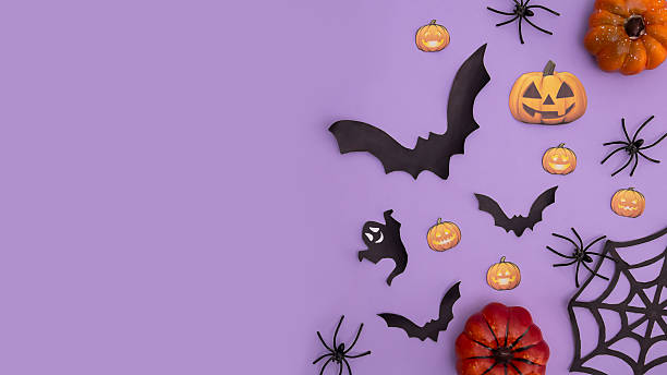 istock Halloween festive background design featuring orange pumpkin, ghost, black bats and spiders. 2229240400