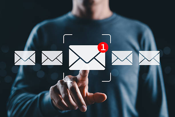 istock New email notification interaction concept. A person interacting with a floating digital interface showing a new email notification symbol, a concept for online communication. E-mail marketing, 2229241841