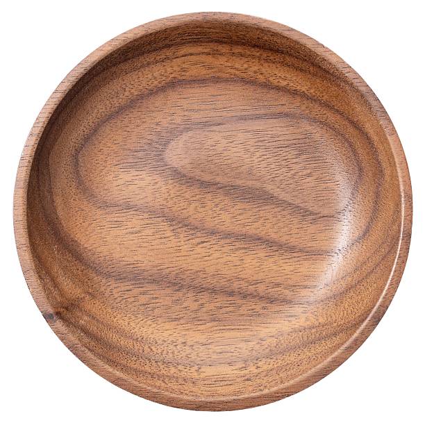istock Round wooden plate with natural grain texture. 2229246154