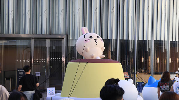 Hong Kong - August 9, 2025: unidentified visitors take photo in front of large exhibition event. The popular Japanese animation Chiikawa has a large exhibition at the Tsim Sha Tsui MTR station and the waterfront, attracting
