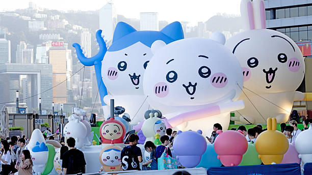 Hong Kong - August 9, 2025: unidentified visitors take photo in front of large exhibition event. The popular Japanese animation Chiikawa has a large exhibition at the Tsim Sha Tsui MTR station and the waterfront, attracting