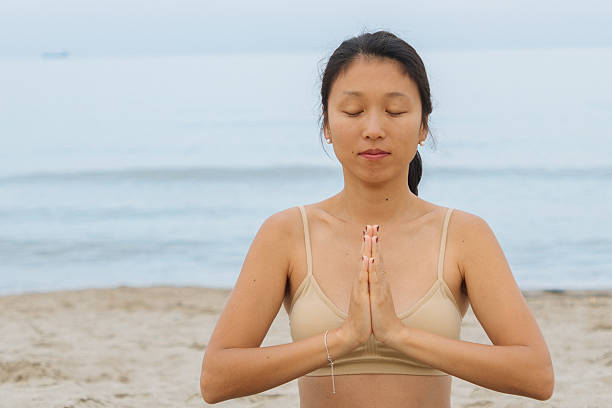 istock Yoga on the beach 2229247044