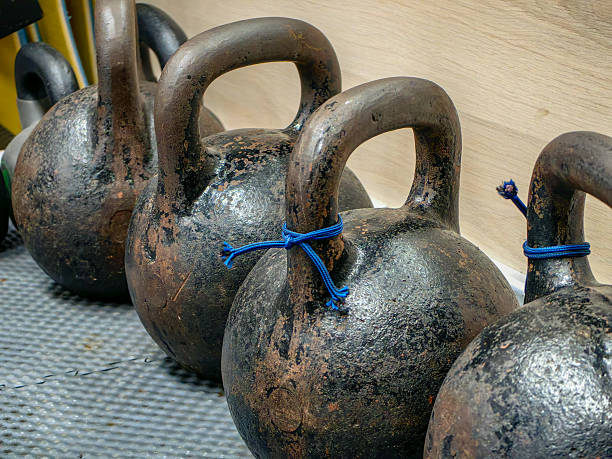 istock A row of heavy, weathered kettlebells, ready for a strength training workout in the gym. 2229247887
