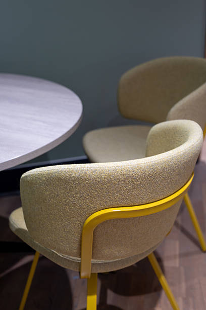 istock Circlular Desk with 2 Beige and Yellow Chairs 2229247913