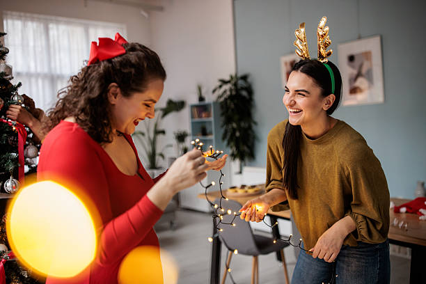 istock Women Decorating with String Lights on New Year’s Day 2229249354