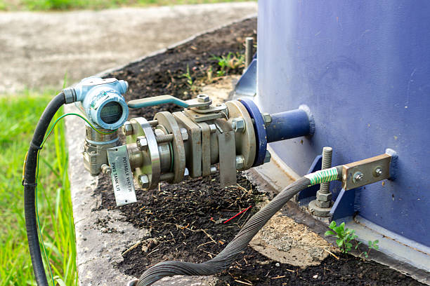 istock Industrial Tank Pressure Transmitter and Grounding System Close-Up Heavy Duty Cable Secured to Structure Industrial Components Showing Connection Details Safety Ground Wire 2229249527