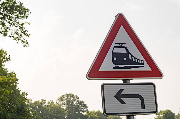 Unguarded railway crossing sign indicating turning left in borken, germany