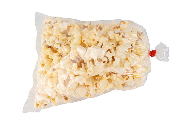 istock Popcorn in a Plastic Bag Tied with a Rubber Band on White Background 2229254477