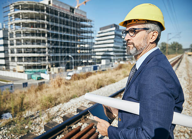 istock senior businessman architect helmet construction site building architecture tablet computer protective workwear blueprint plan 2229256994