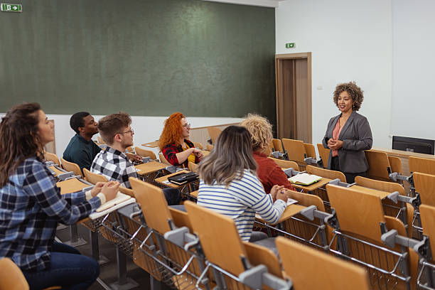 istock Mixed Race Female Lecturer Engaging With Students in Lecture Hall 2229260115