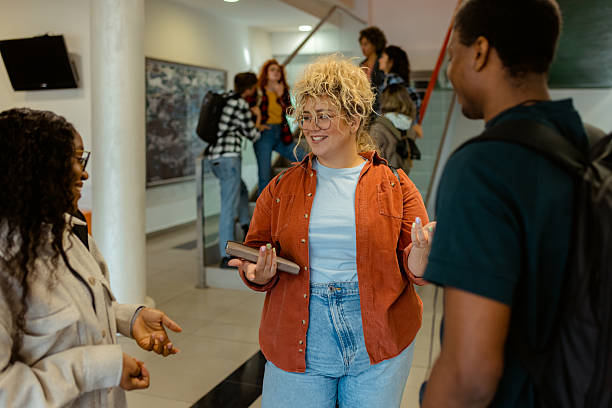 istock Happy College Friends Talking After Class in Campus Building 2229260324