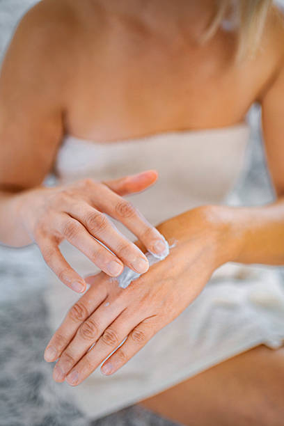 istock Woman applying moisturizing cream on her hands after shower 2229262036