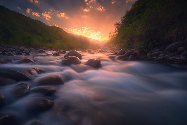 istock Magical sunrise over fast flowing mountain river 2229263157