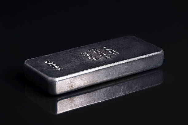 Old and scratched silver bar, side view, on black glass