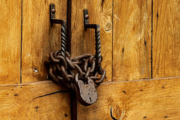 An old lock and chain on a barn door