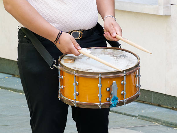 istock Drummer playing snare drum with drumsticks during outdoor event 2229268620