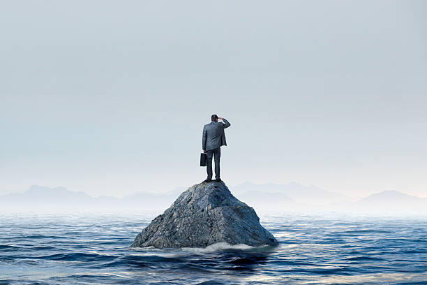 istock Man Stranded On Island Looks Toward Mainland In tThe Distance 2229273025