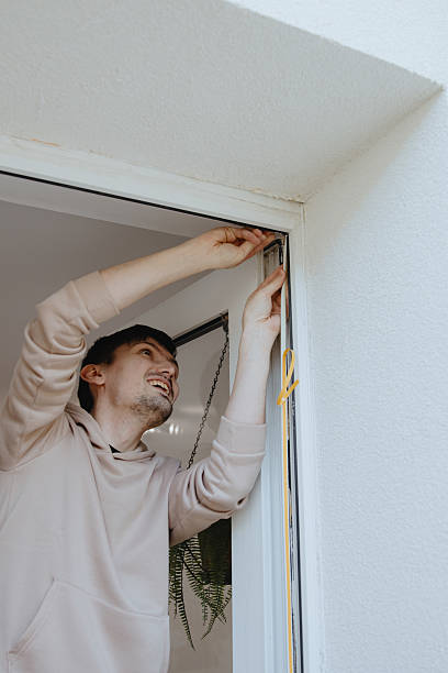 istock One young man is gluing a rubber profile to a door frame. 2229278462