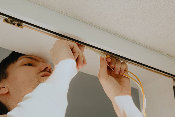 istock A young man glues a rubber profile to a door frame. 2229280041