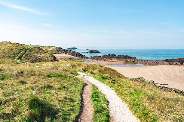 Picturesque coastal path leading to the beautiful llanddwyn beach, a popular tourist destination on the isle of anglesey in north wales