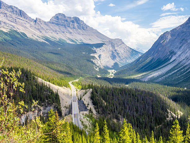 istock Car driving along Icefields Parkway toward towering Rocky Mountains 2229286437