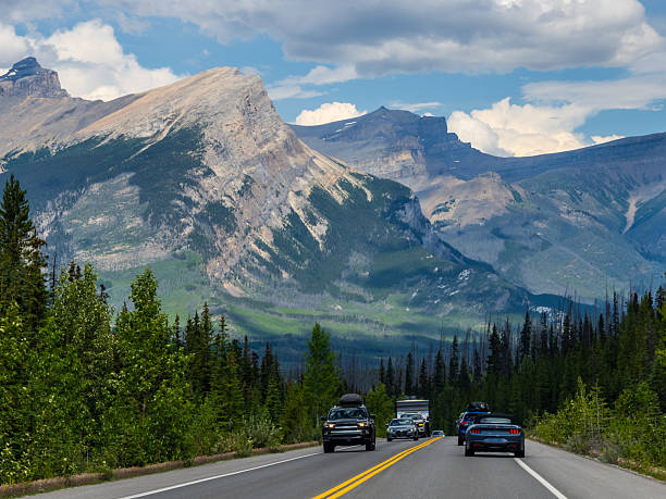 istock Car driving along Icefields Parkway toward towering Rocky Mountains 2229286448