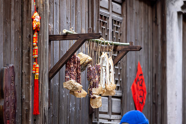 Chinese style bacon are hanging outside of window or house for sunshine after made to finalized the last step.