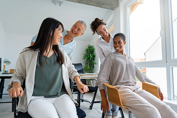 istock Coworkers laughing and enjoying teamwork in a bright office setting 2229292362