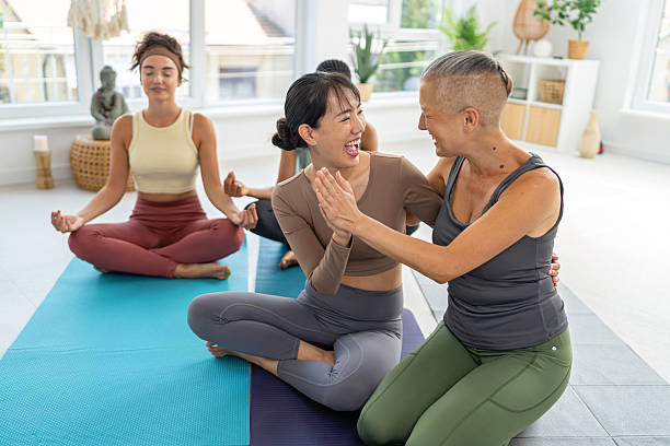 istock Four female friends bonding during a yoga session in a serene studio environment 2229296147