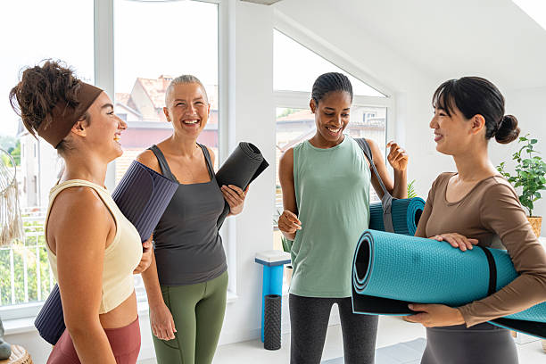 istock Group of women enjoying yoga with mats in a bright studio setting 2229299862