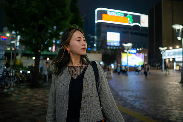 istock Young female freelance worker standing on city at night 2229304796
