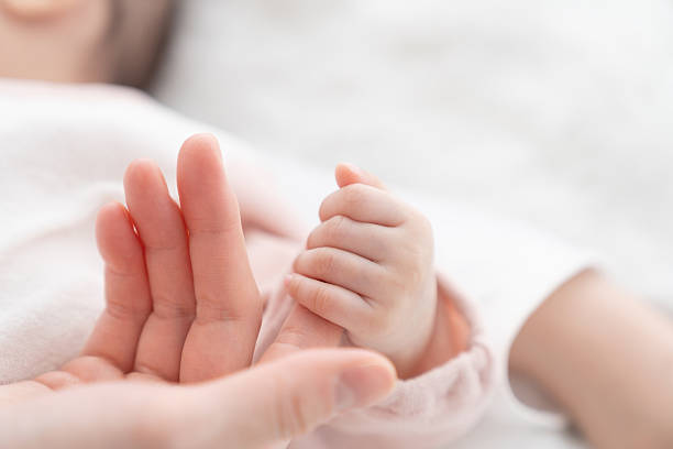 istock baby's hand and mother's hand 2229309340