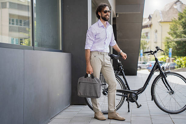 istock Urban businessman commuting with bicycle in modern city environment 2229312140