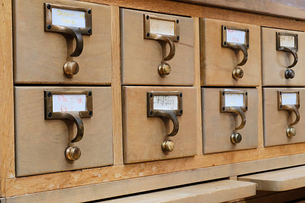 database concept. vintage cabinet. human hand opens library card or file catalog box.