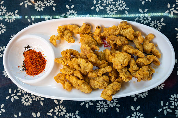 istock Xiao Shu Rou. Crispy fried pork snacks served on a white platter 2229314657