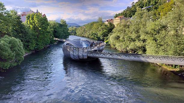 Modern architectural structure known as the Murinsel, a floating platform and pedestrian bridge on the Mur River in Graz, Austria stock photo