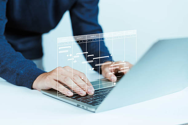 istock Project manager concept working with Gantt chart to plan and deliver tasks. Schedule activities with strategic planning software. Set deadlines and important dates. White background. 2229315853