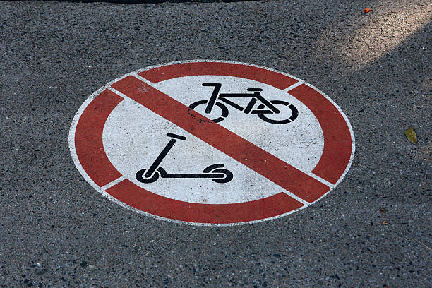 istock No Bicycles or Scooters sign painted on an asphalt bitumen surface 2229321031