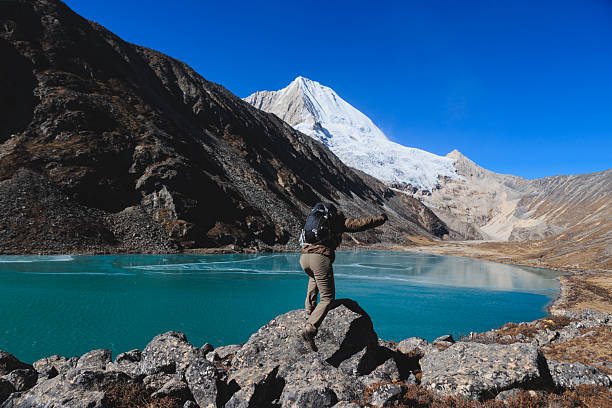Mt. Everest snow capped summit overlooking the Ngozumpa Glacier and the Sherpa teahouses at Gokyo high in the Himalayan mountains of Nepal.