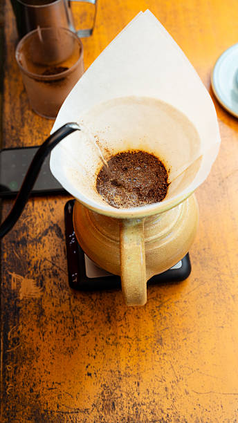 istock Barista pouring hot water on coffee grounds for aromatic beverage 2229326804