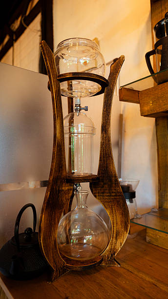 istock Elegant cold brew coffee maker on wooden stand in cafe 2229326839
