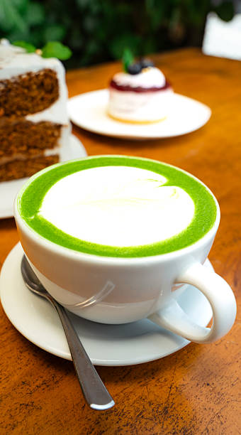 Matcha latte with latte art and pastries on a table