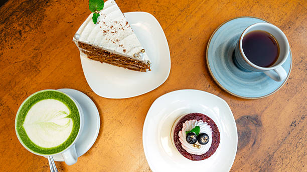 Coffee, matcha latte and delicious desserts on a wooden table