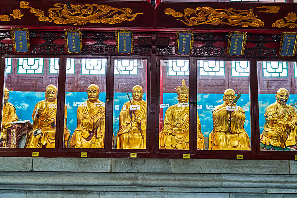 Gold coated buddhist staues lined up at Wat Pho temple. Phra Nakhon District. Bangkok. Thailand.
