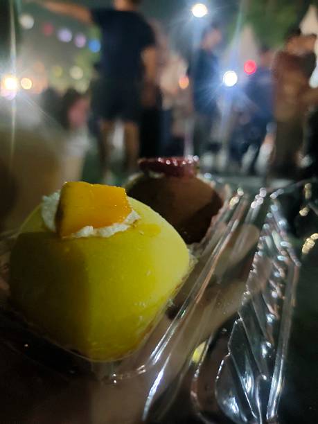 A person holds two fruit mochi