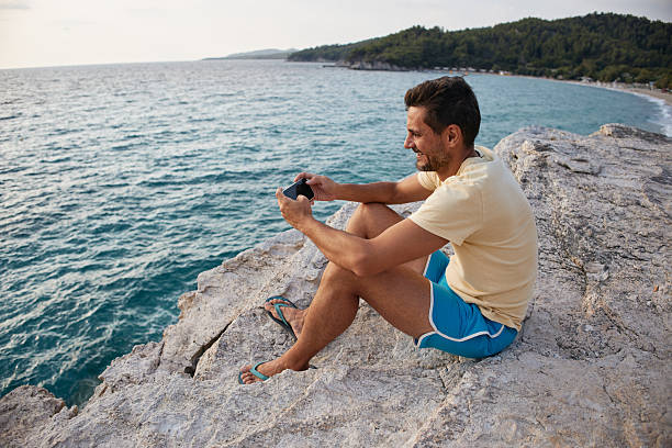 istock Young adult using his phone 2229332238