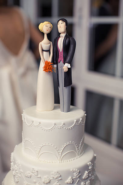 istock Elegant White Wedding Cake With Modern Bride And Groom Figurine Topper 2229338821